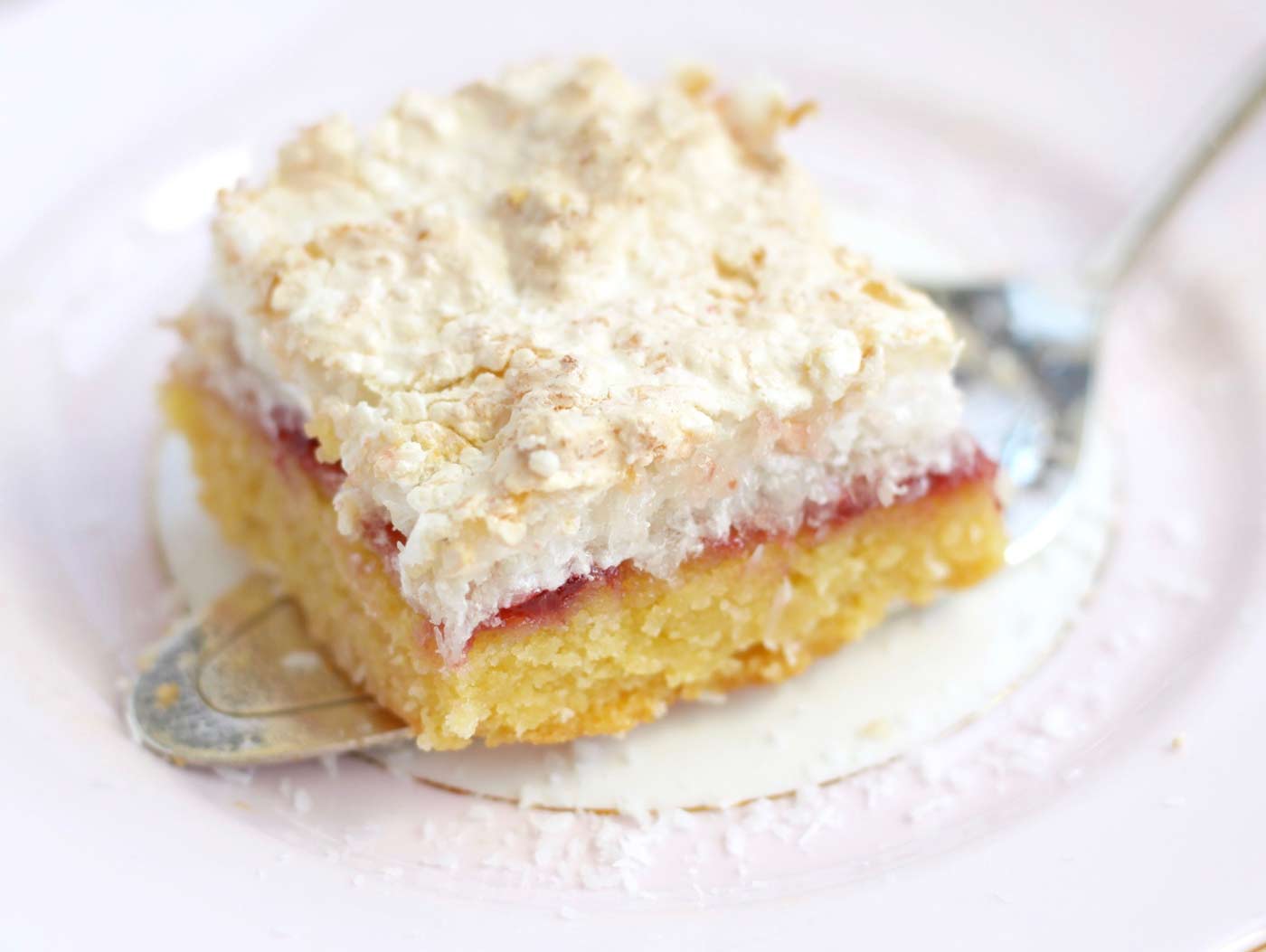 close up of louise cake slice cut and on a serving spatula