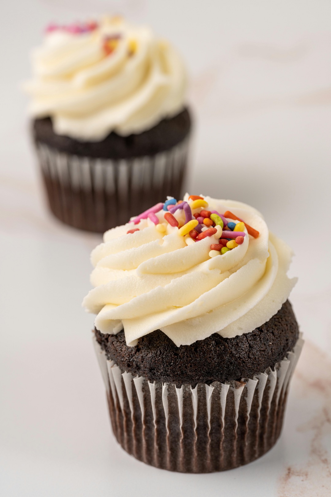 perfect buttercream on a chocolate cupcake with sprinkle on top