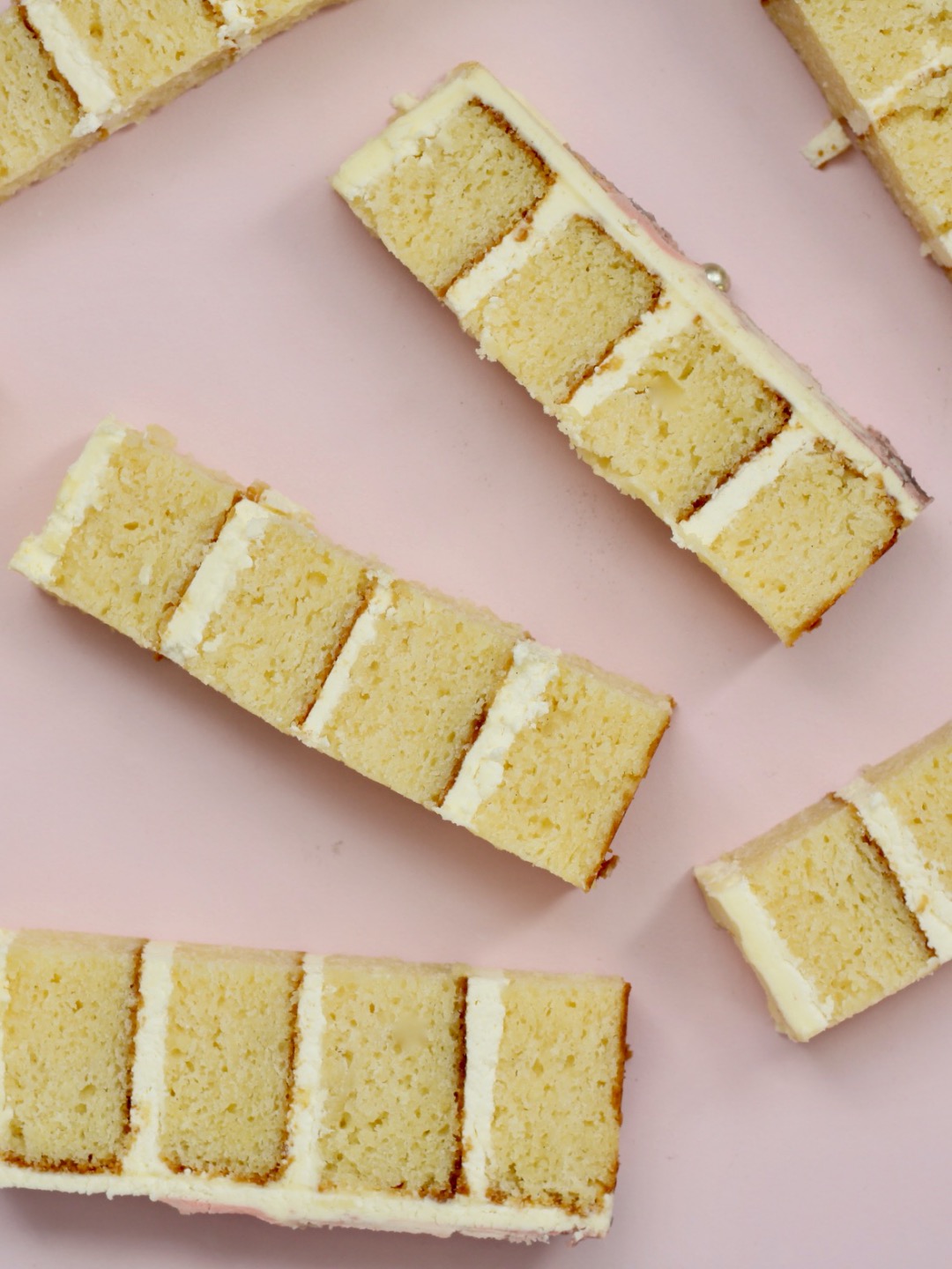 pieces of gluten free vanilla cake displayed on a board