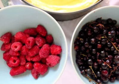 one bowl of fresh raspberries and another of fresh blueberries
