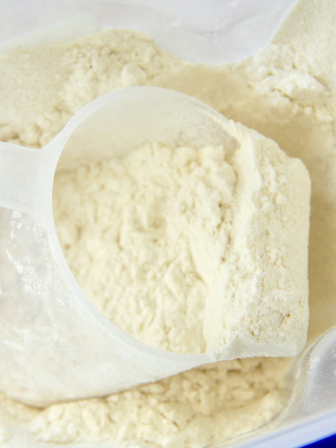 A cup of flour scooped from flour container