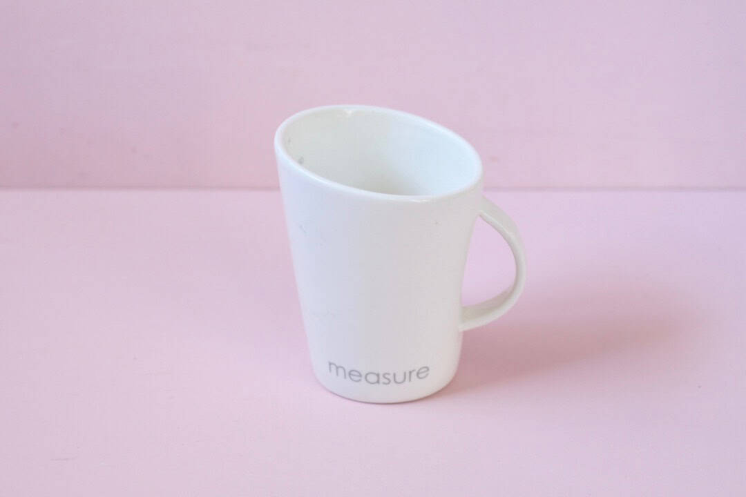 White measuring cup with handle.