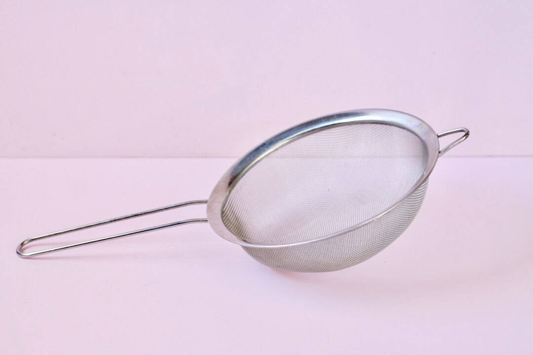A sieve with pink background