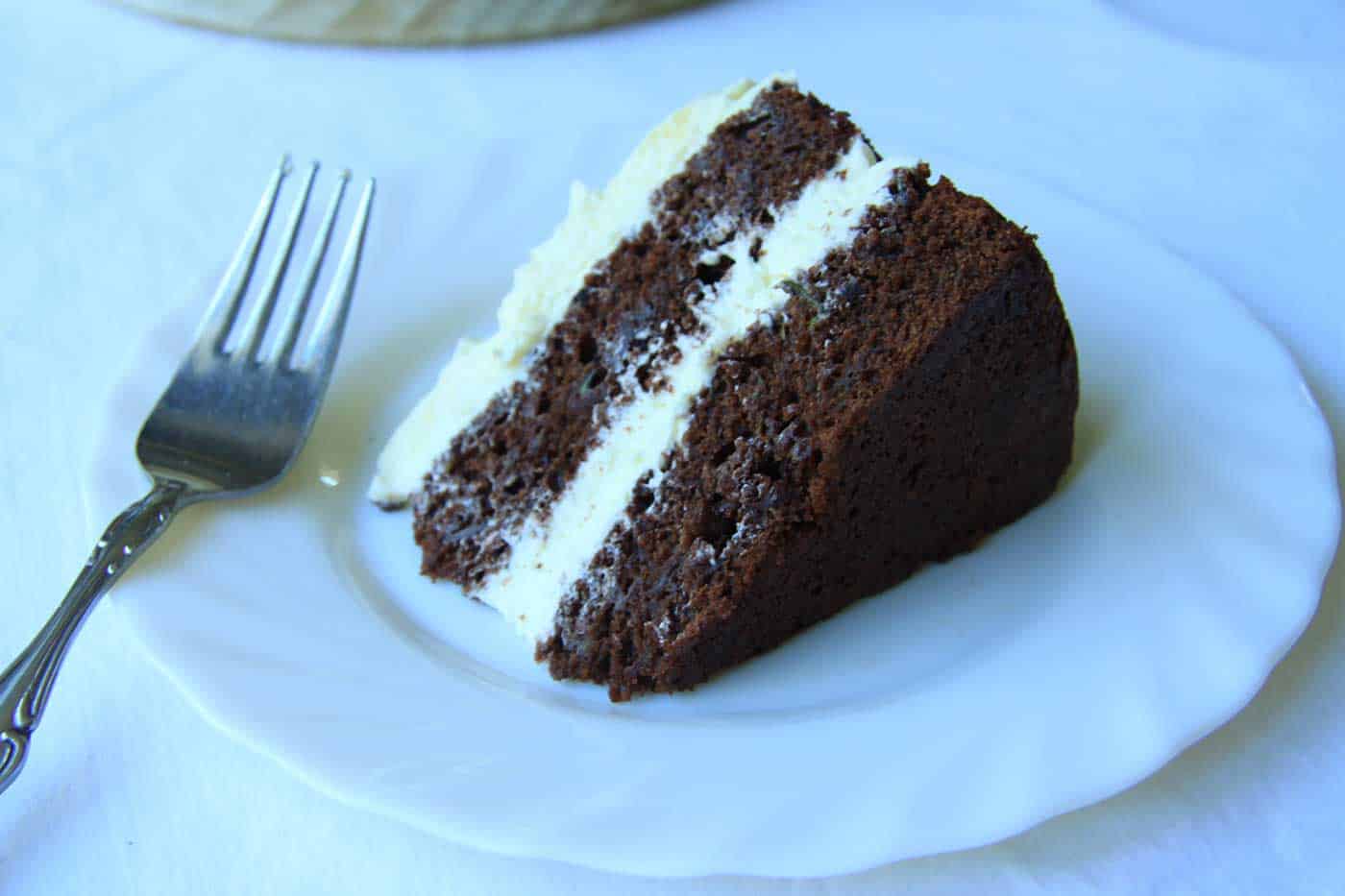 A piece of chocolate zucchini cake on a plate, ready for eating