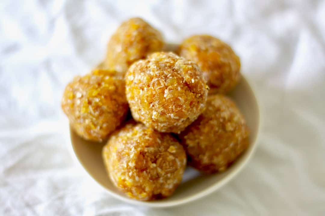 Apricot almond slice rolled into bliss balls, in a dish