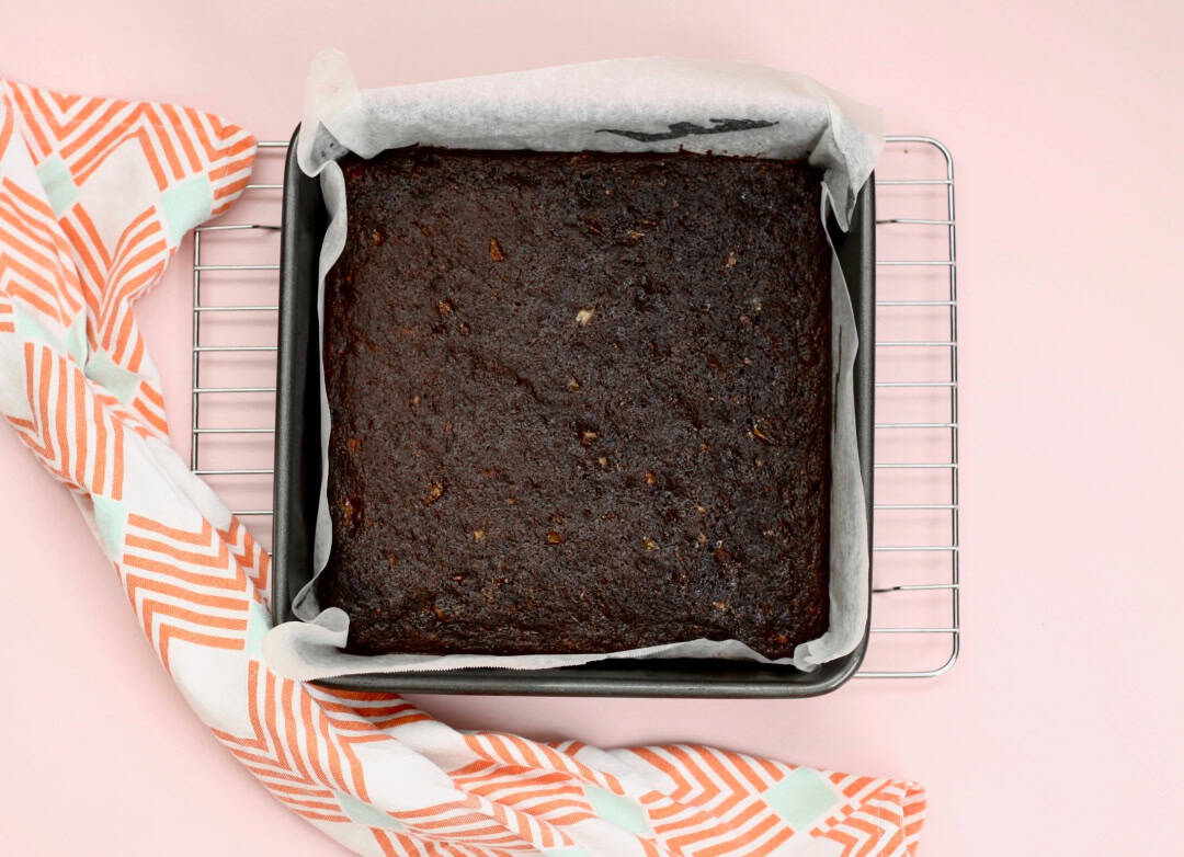 A batch of healthy chocolate brownies in the pan on a cooling rack