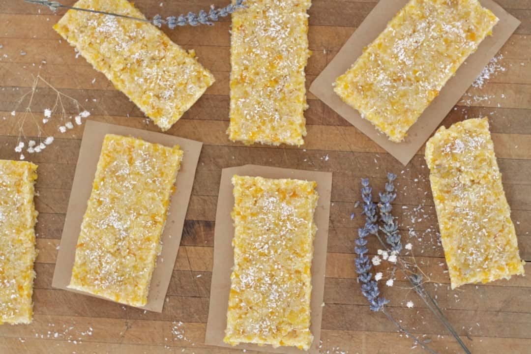 Slices of almond apricot slice on pieces of baking paper