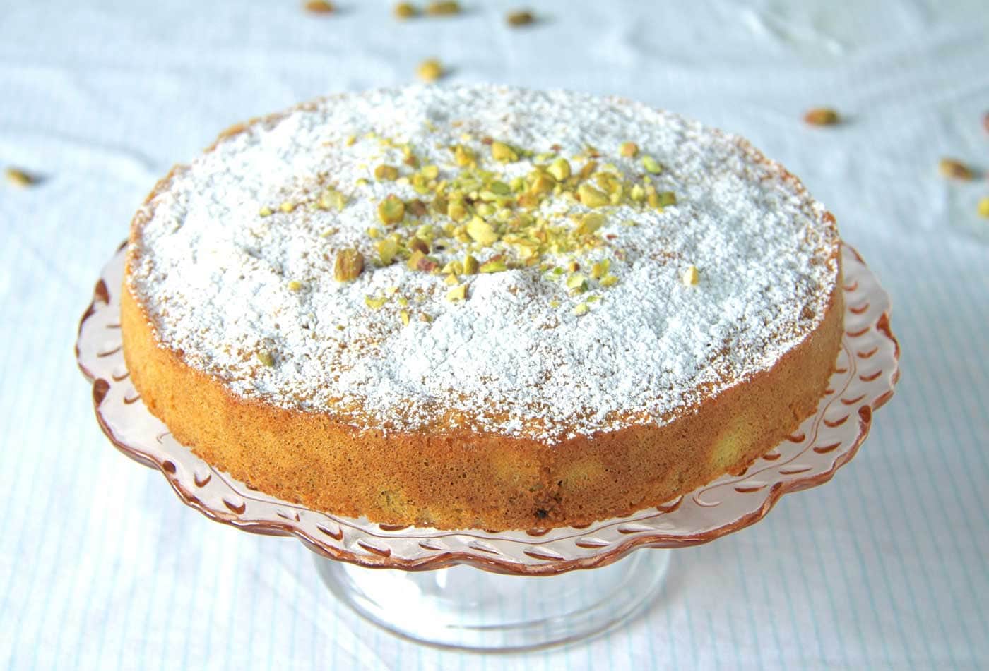 An Italian Pistachio cake on a cake stand.