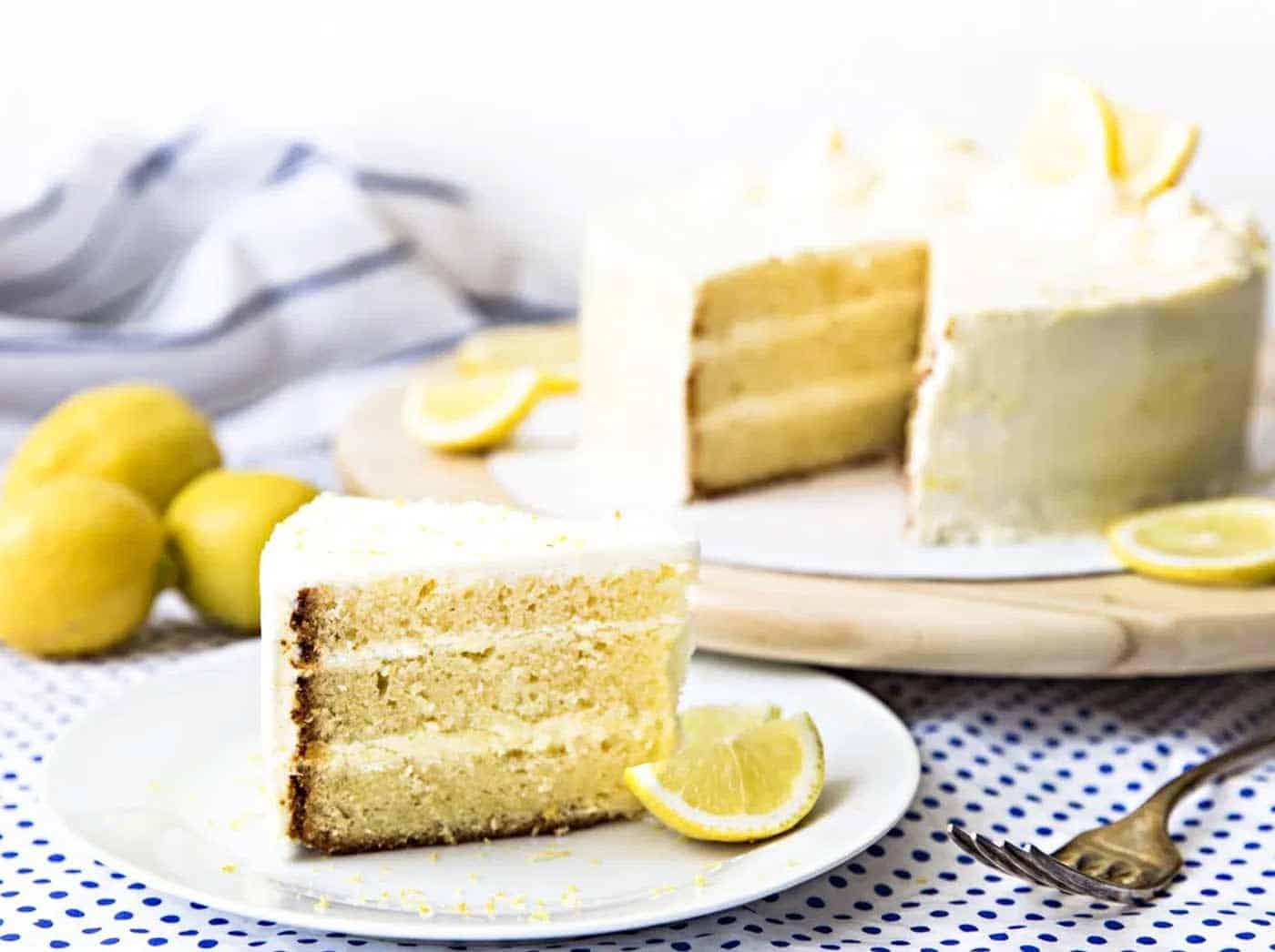 Lemon layer cake slice with lemon wedge