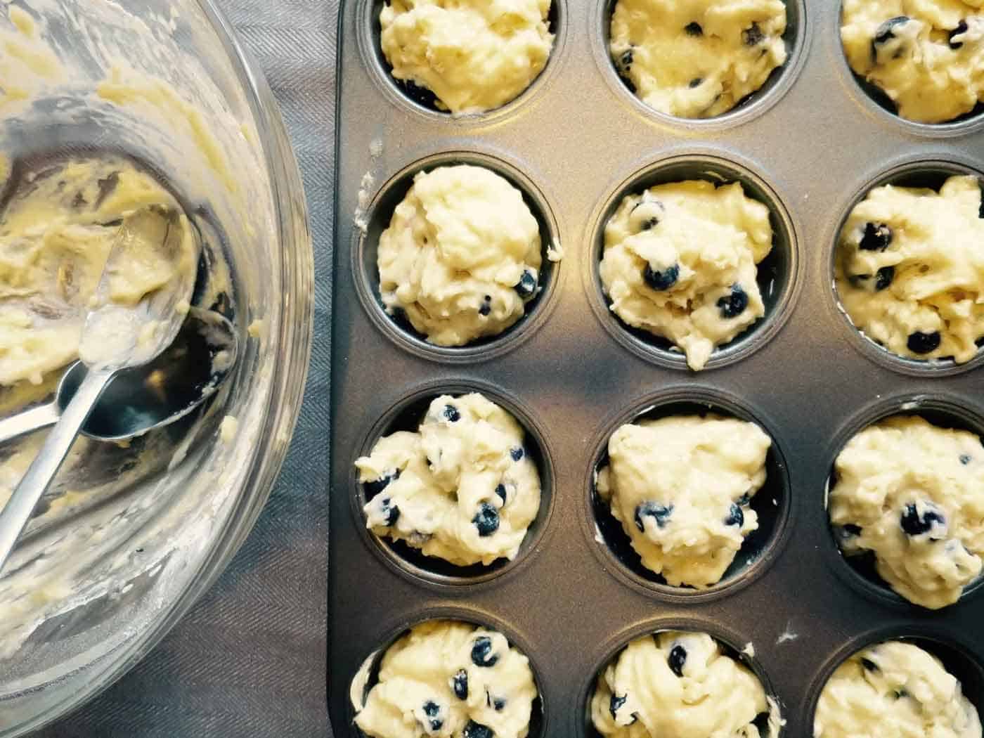 Lemon blueberry muffin batter in the pan ready for baking.