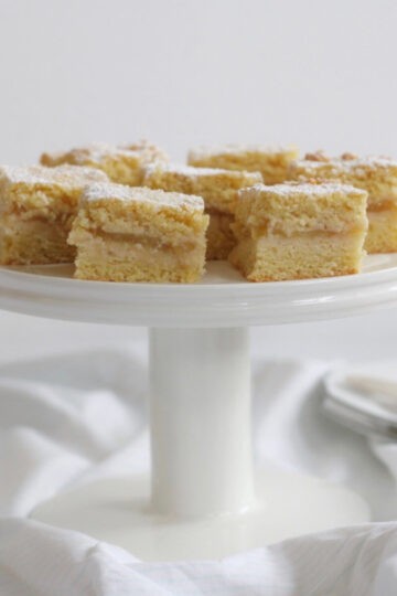 Pieces of apple shortcake on a cake stand.