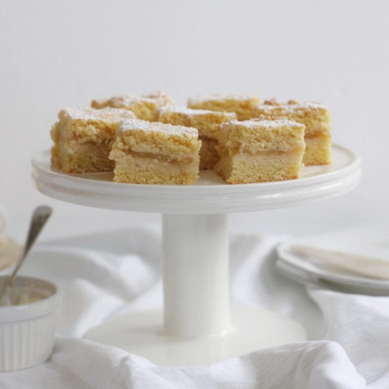 Pieces of apple shortcake on a cake stand.