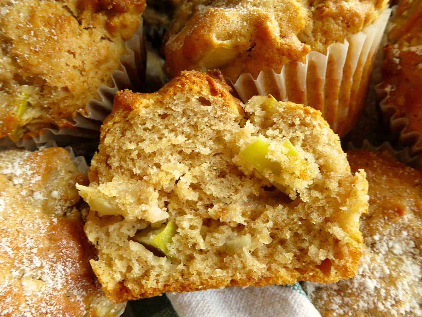 Close up of an apple walnut muffin which has been cut in half.