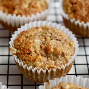 Banana bran muffin on a cooling rack with a few others in the background.