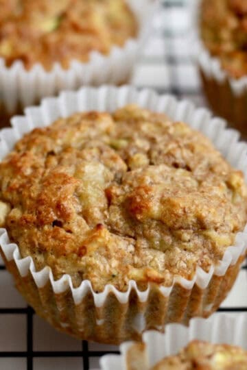 Banana bran muffin on a cooling rack with a few others in the background.