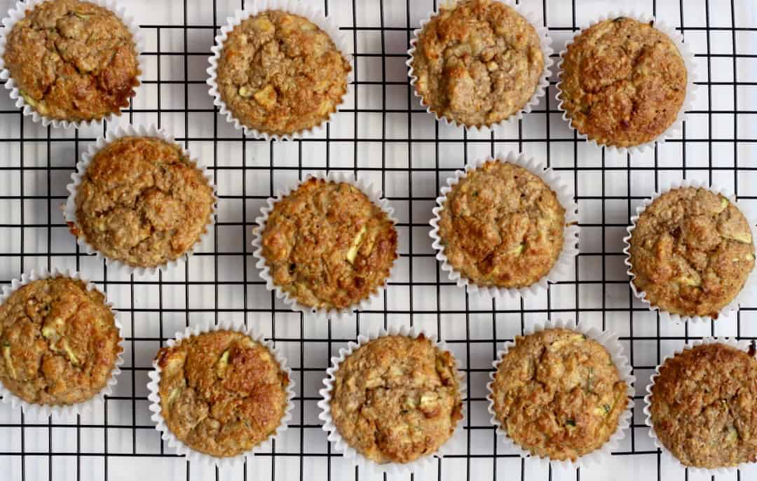 Banana Bran Muffins spread out on a cooling rack.