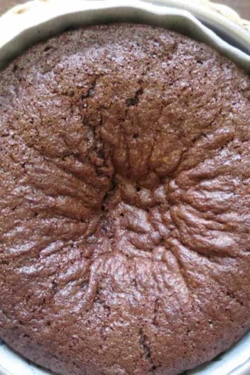 A chocolate cake with a sunken hole in the middle.