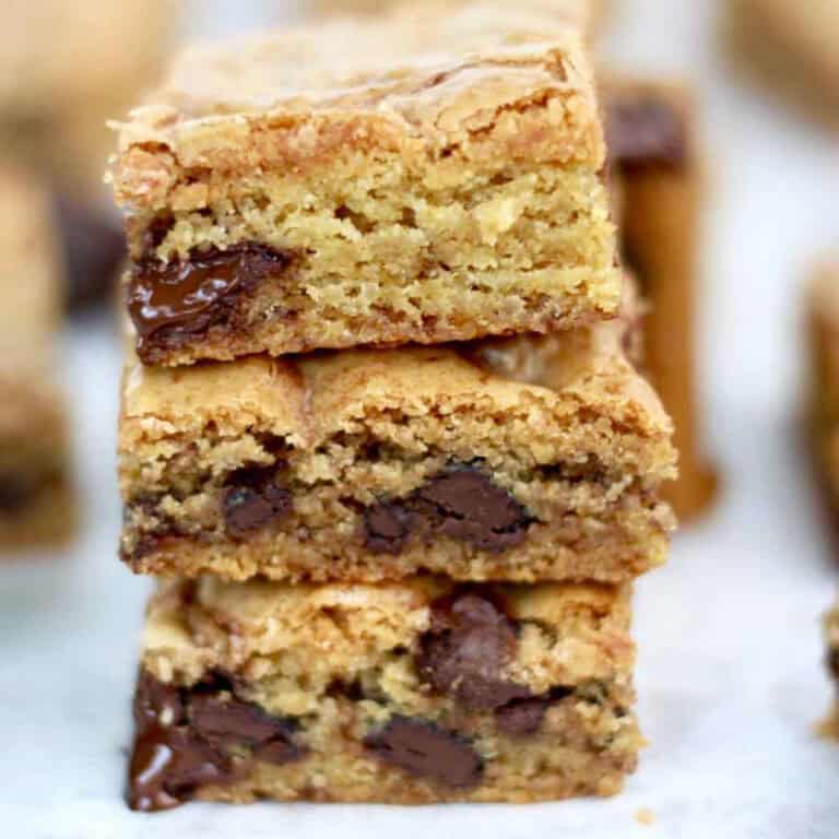 Three moorish chocolate cookie slices stack on top of each other. Each one is stuffed with chocolate chunks.