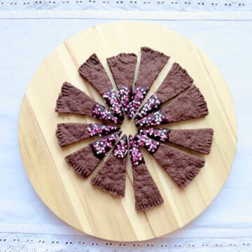 Melt-in-your-mouth chocolate shortbread wedges arranged in a circle. Each end has been dipped in chocolate and covered with sprinkles.