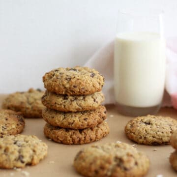 Chocolate chunk lactation cookies next to a glass of milk.