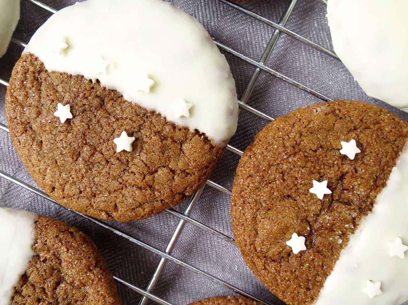 Fully iced cookies decorated with star sprinkles.