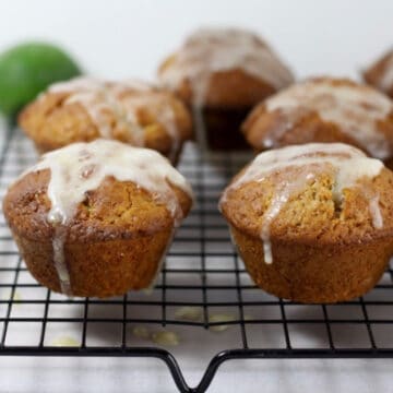 Feijoa muffins on a cooling rack drizzled with glaze.