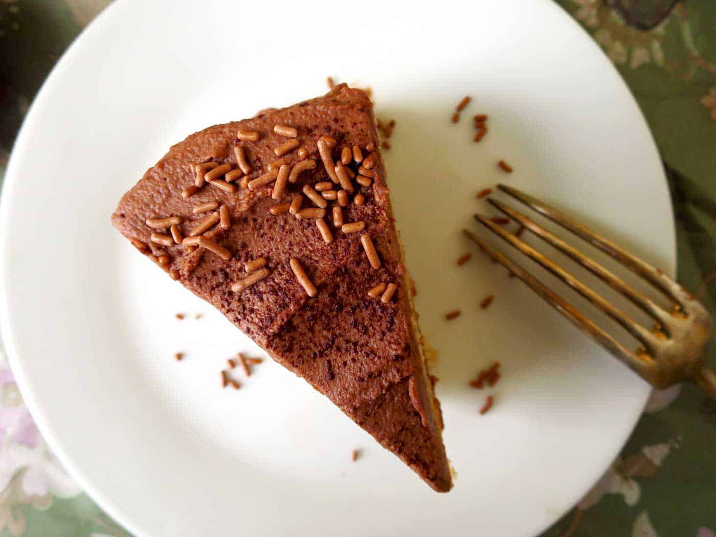 A slice of banana chocolate cake on a plate with fork.