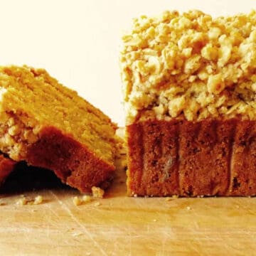Sliced pumpkin bread with crumble topping.