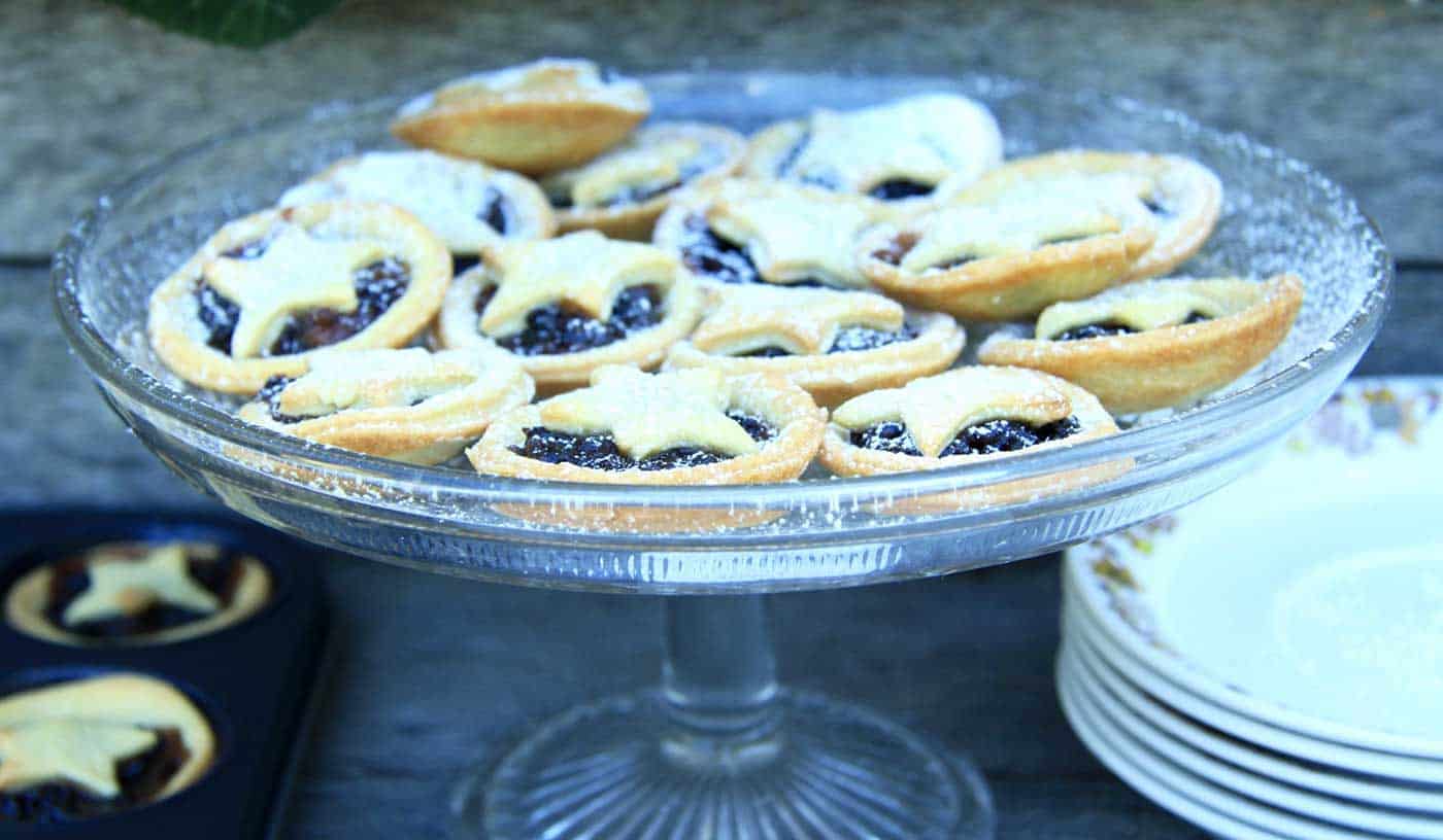 Side view of the cake plate filled with mini star topped Christmas mince pies.