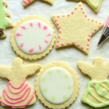 Perfectly iced sugar cookies in the shapes of circles, angels, and Christmas trees.