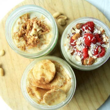 Three jars filled to the brim with overnight oats. There are three different flavours - raspberry coconut on the right, banana bread at the bottom and peanut butter on the top left.