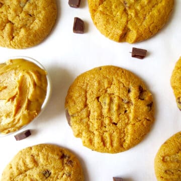 Chocolate Chunk and Peanut Butter Cookies on a white board with a little bowl filled with peanut butter next to it.