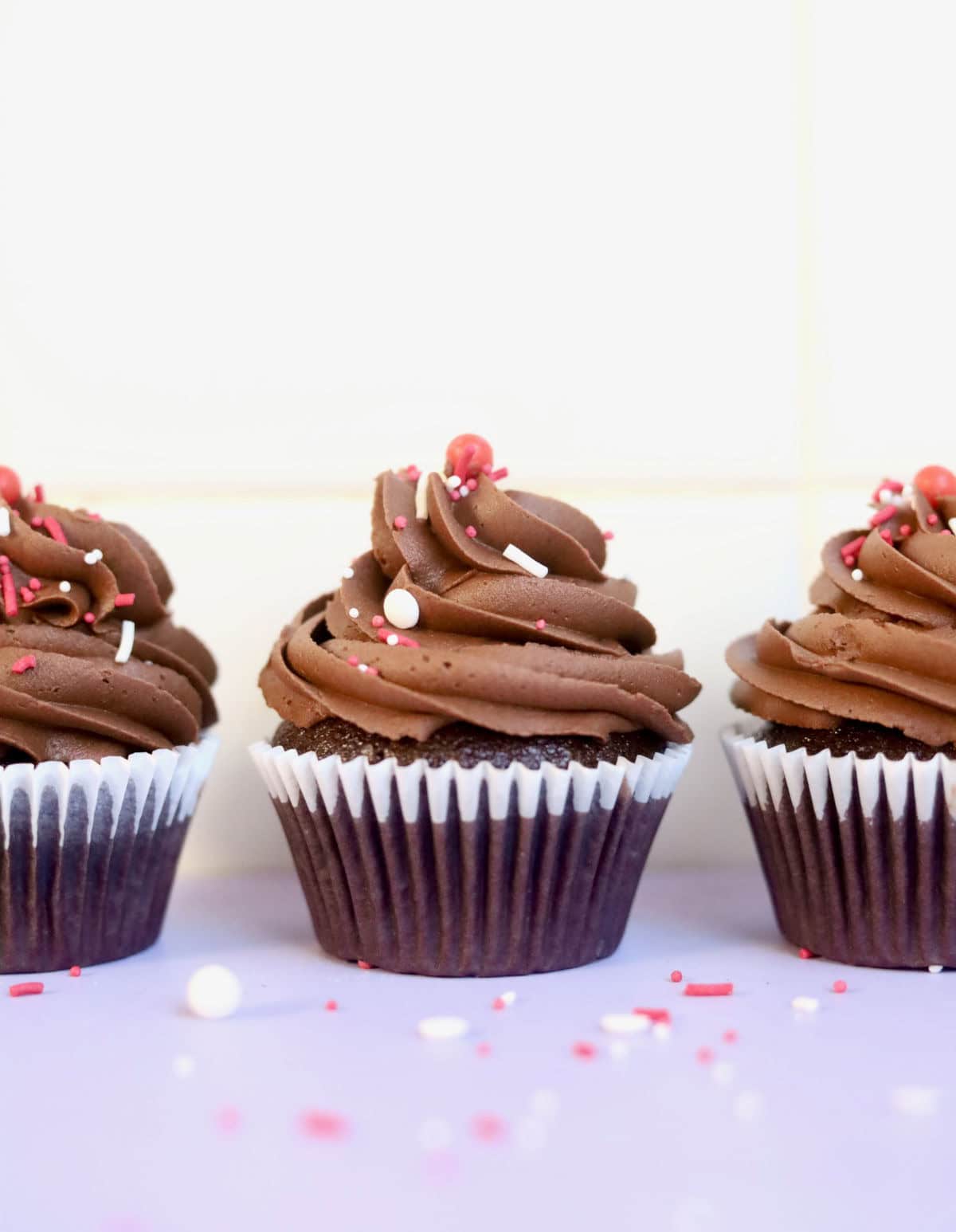 Three decadent chocolate cupcakes in a row.