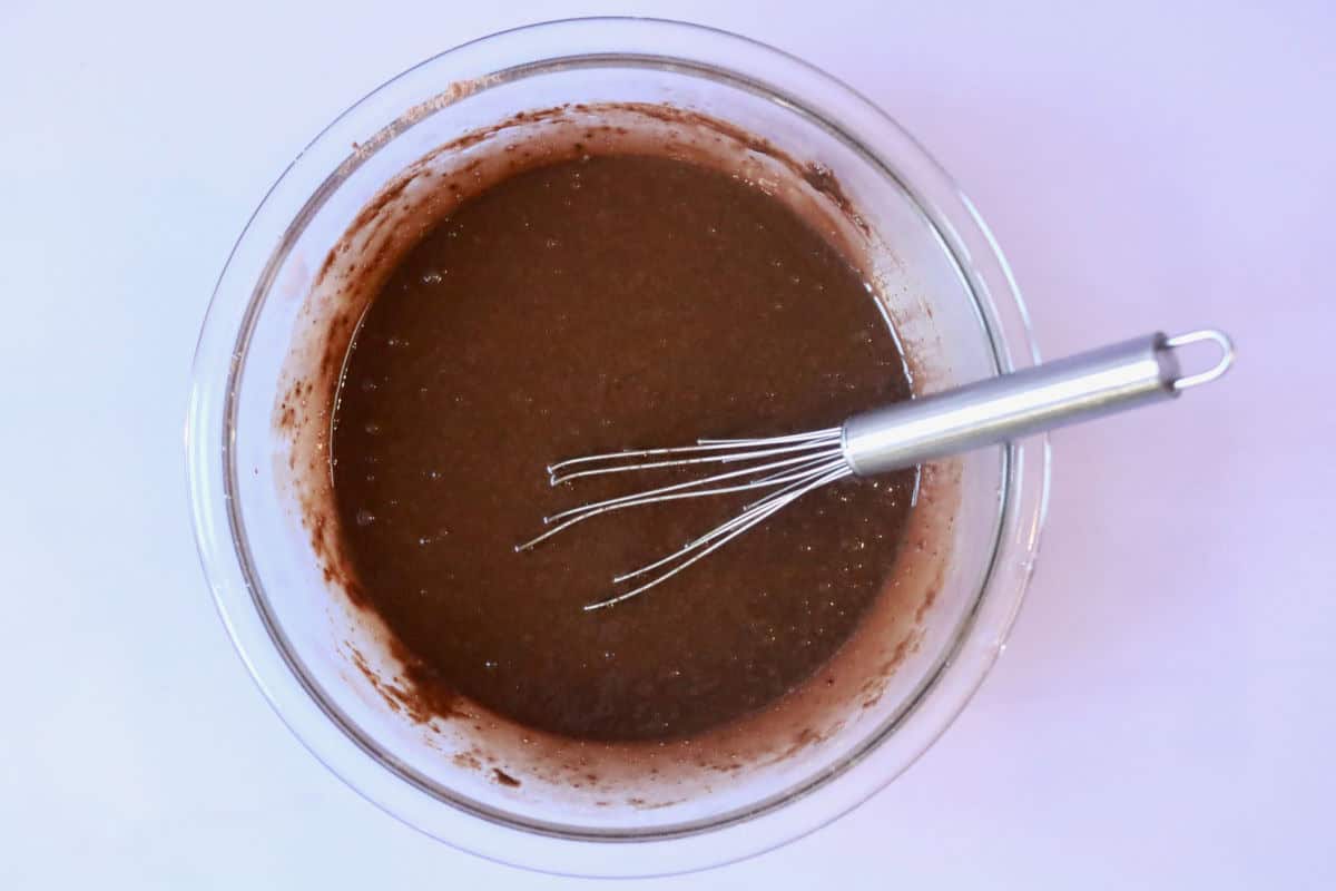 Chocolate cupcake batter fully mixed with all ingredients. The mixture is runny as it should be.