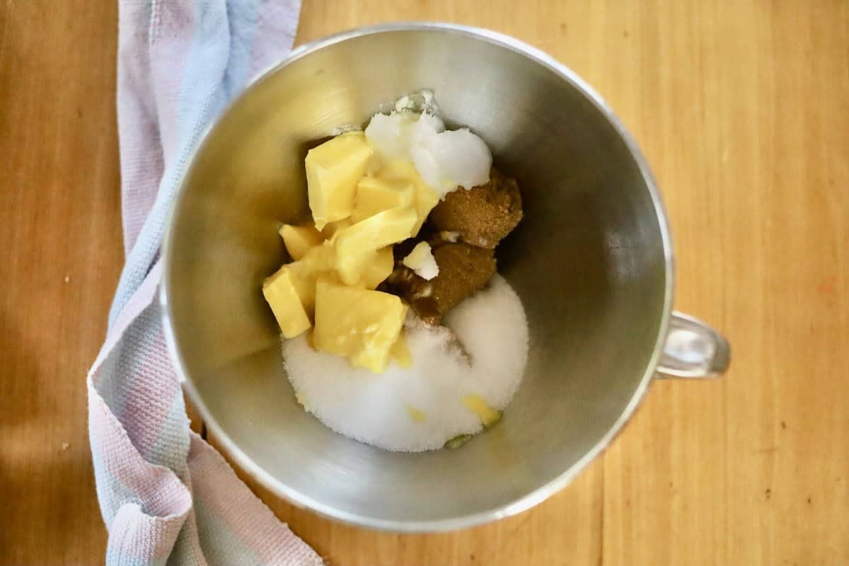Lactation cookie ingredients (brown and white sugars and butter) in a KitchenAid mixing bowl, ready for beating.