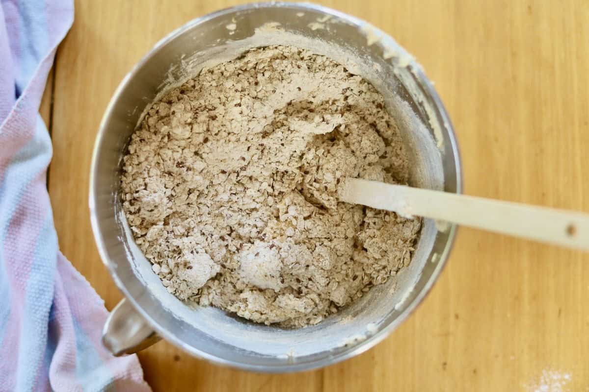 The dry mixture is being folded into the creamed mixture.