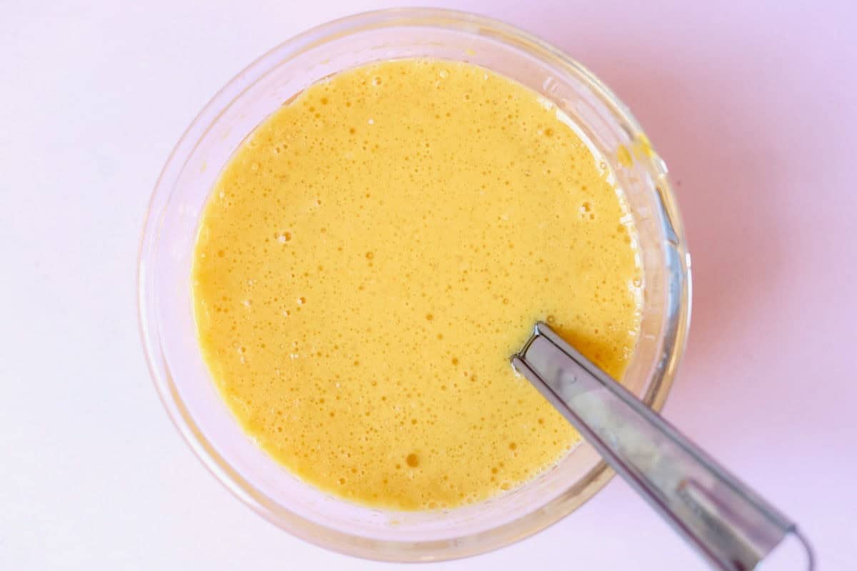 A small glass bowl with whisked wet ingredients.