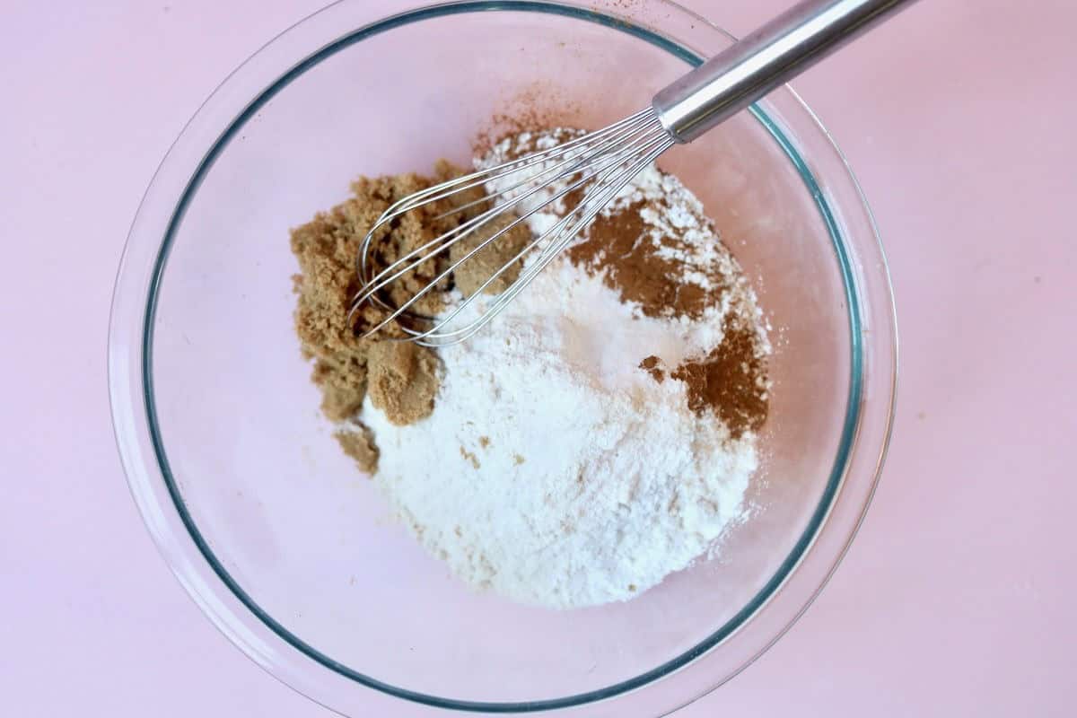 A glass bowl with dry ingredients before they have been whisked together.