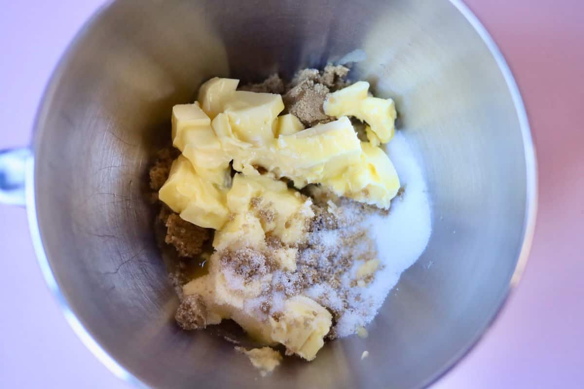 Softened butter, brown sugar and white sugar in the mixing bowl of a stand mixer.